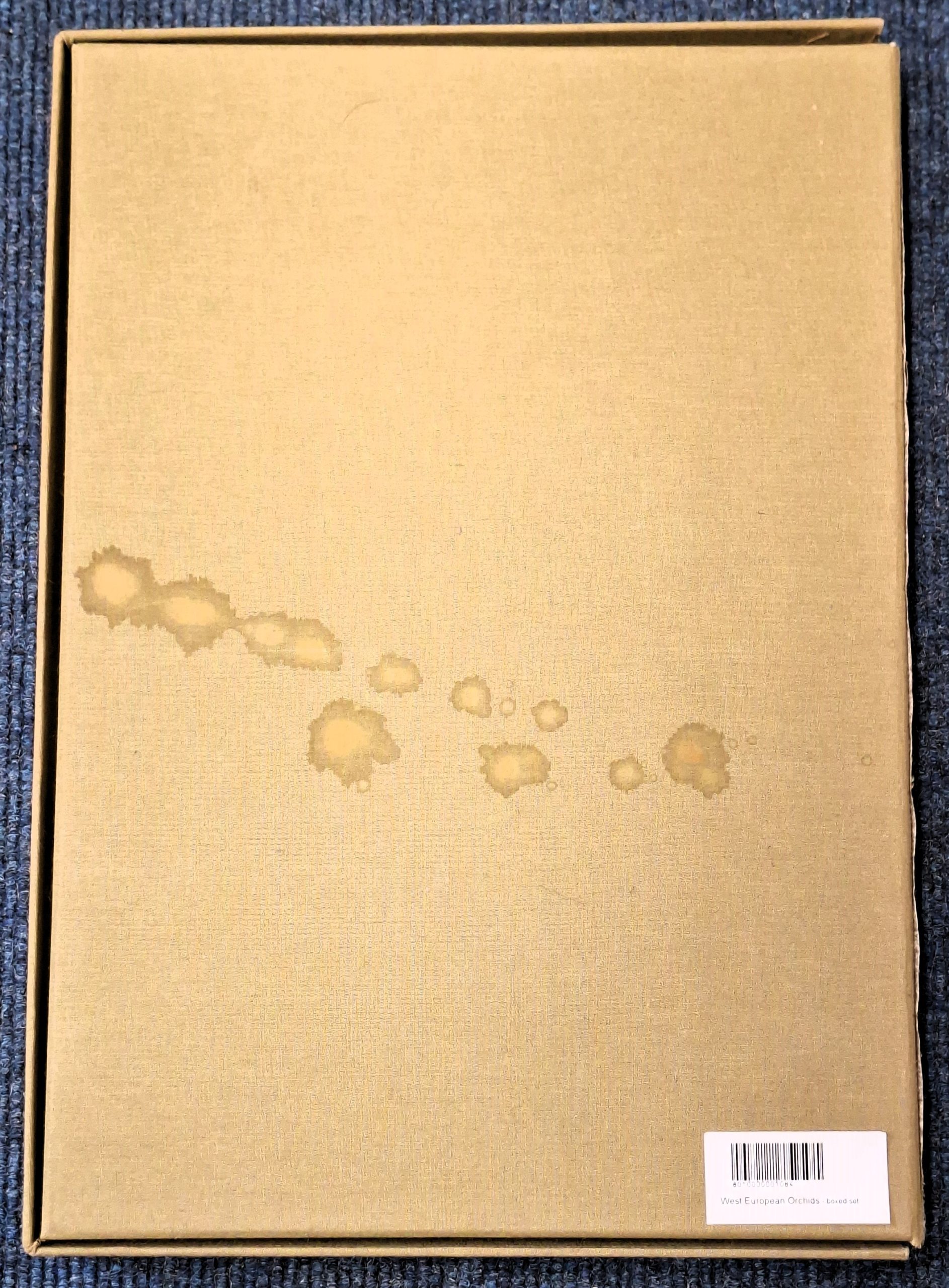 Back of slipcase of West European Orchids, showing stain marks