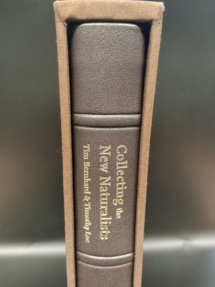 Top portion of the spine of the leather bound version of Collecting the New Naturalists, in it's brown cloth slipcase, showing the title and authors in gilt